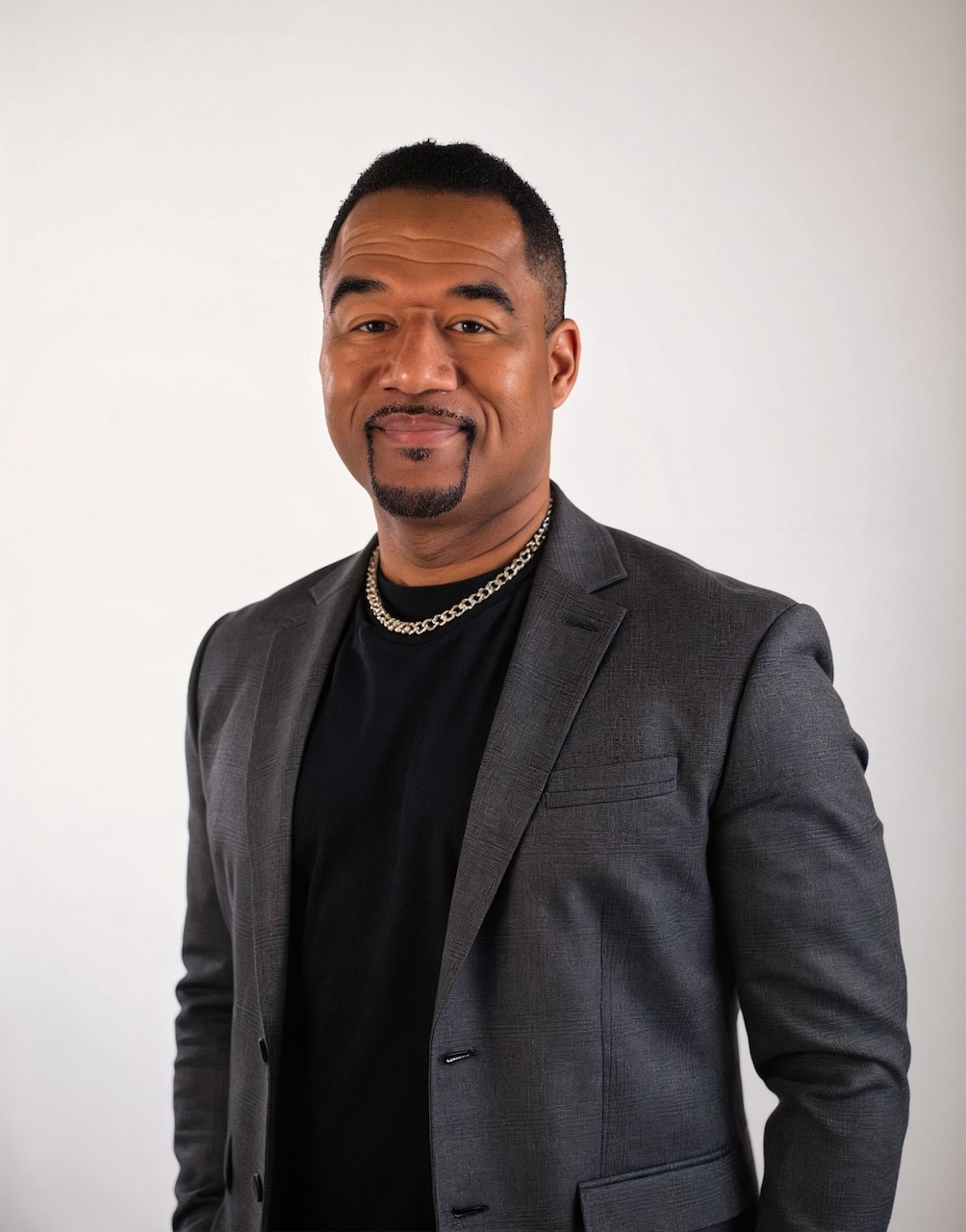 Professional portrait of Darryl Mack in a suit